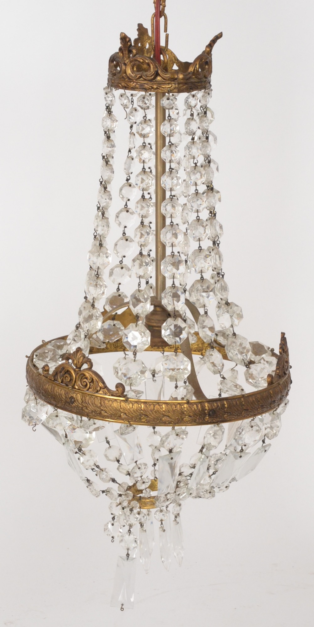 A mid 20th Century ceiling light fitting with swagged prismatic crystal droppers to a gilt metal