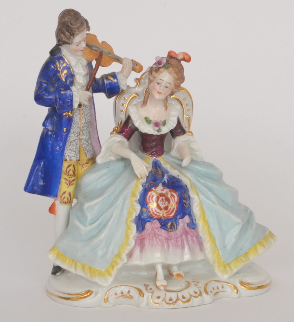 A 20th Century figural group of a seated lady being serenaded by a violinist, unmarked, height 18cm,