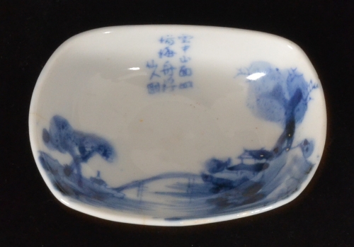 A small 19th Century Chinese blue and white dish of oval form hand painted in underglaze blue with a