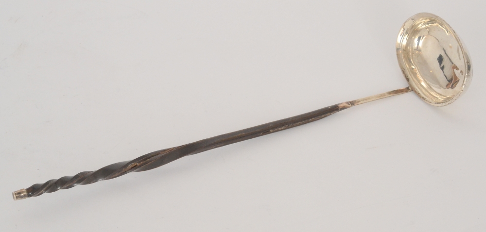 A Georgian silver toddy ladle, plain oval bowl below twisted whale bone handle, length 33cm,