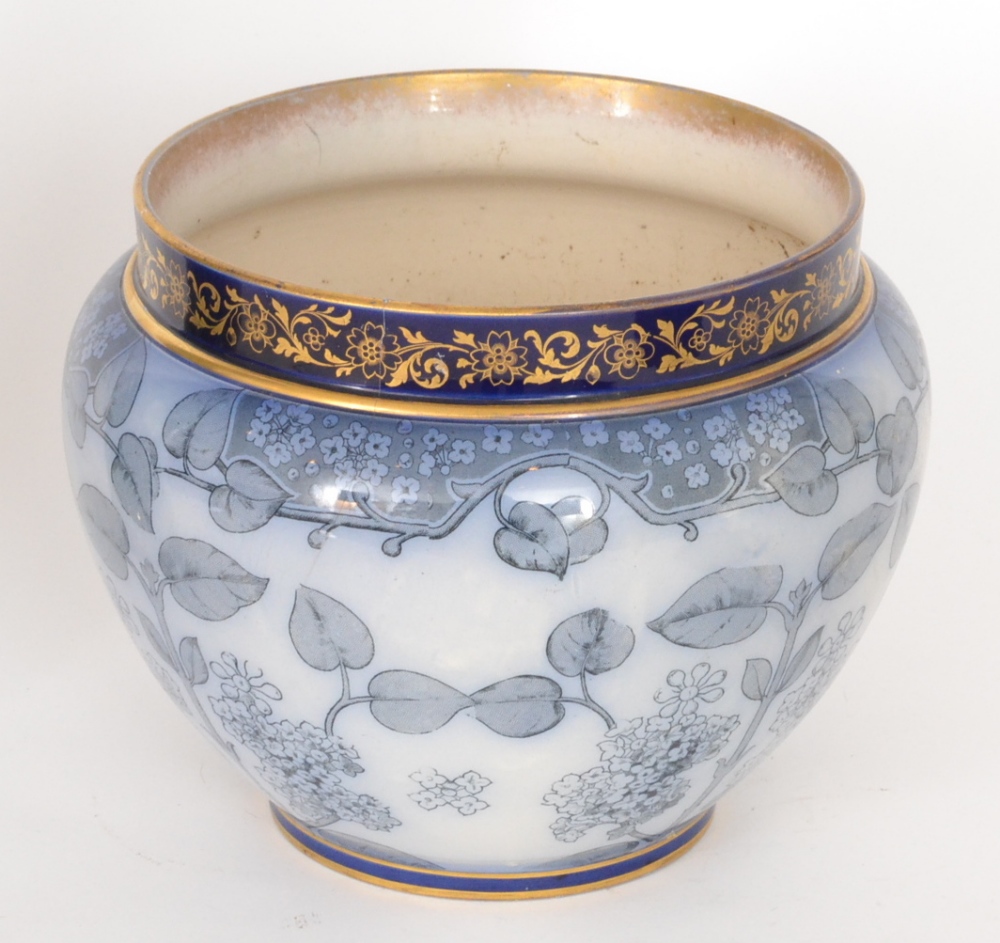 A late 19th Century Doulton Burslem jardiniere decorated with a flo blue and white transfer