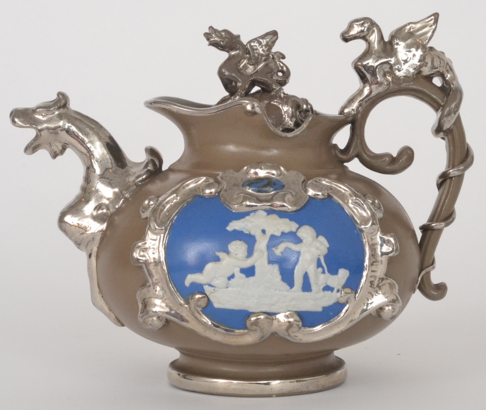 A 19th Century stoneware teapot decorated with a blue and white relief moulded roundel of cherubs