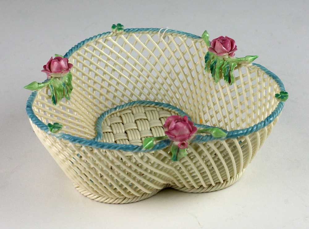 A fine Belleek Shamrock Basket, with red roses and blue borders, strap marks, 16cms (6 1/2"). (1)