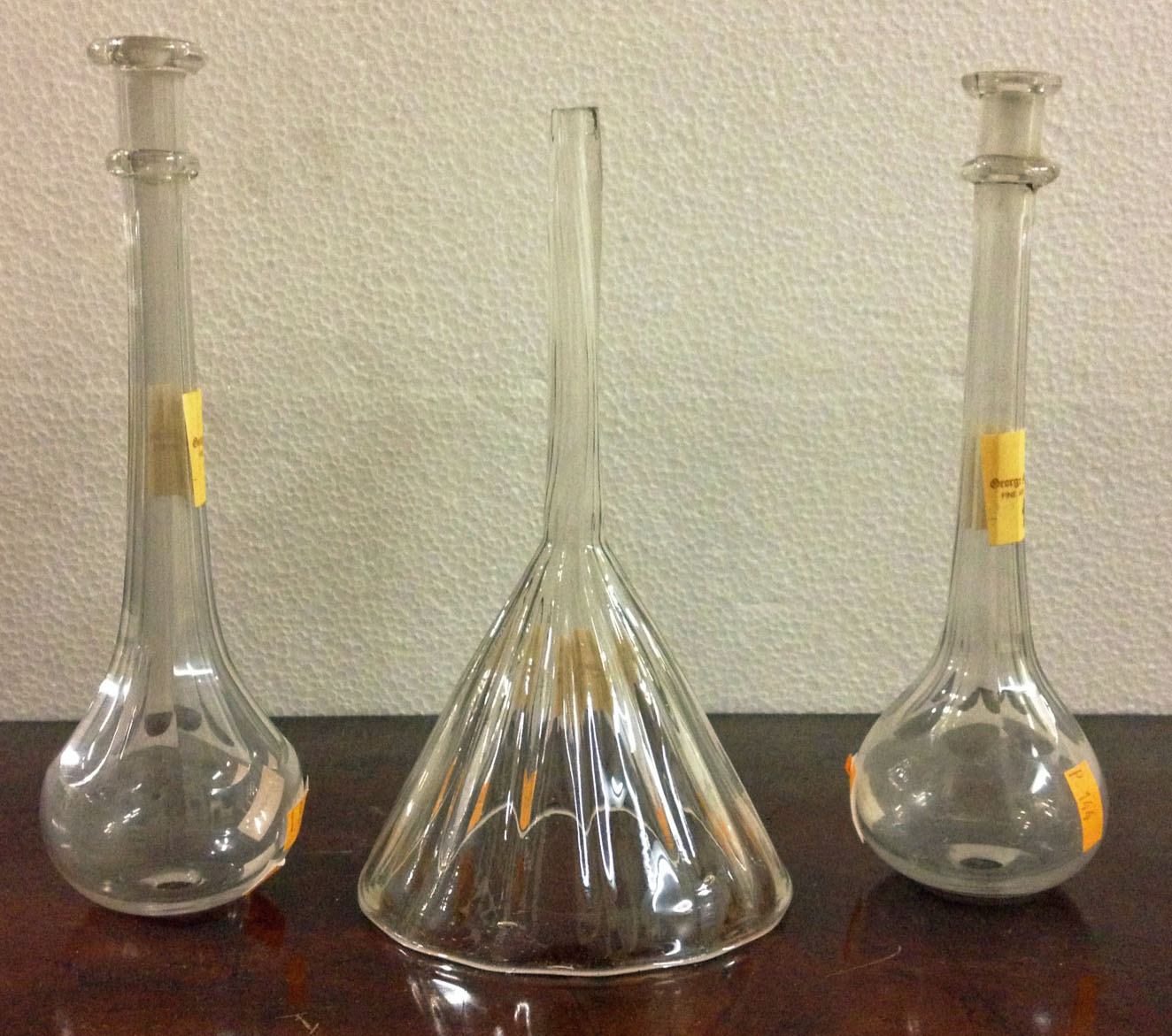 Two similar antique cutglass Toddy Lifters, and an old blown glass Wine Funnel. (2)