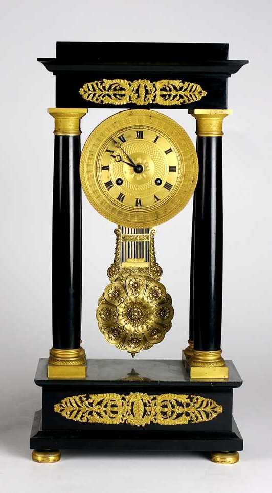 A very good Regency ormolu mounted black marble Portico Clock, c. 1830, the case with stepped top