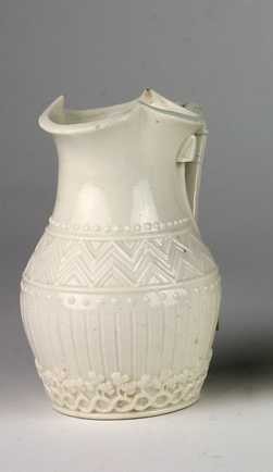 A rare First Period Belleek Jug, with Celtic design handle and shamrock, blue mark, and registration