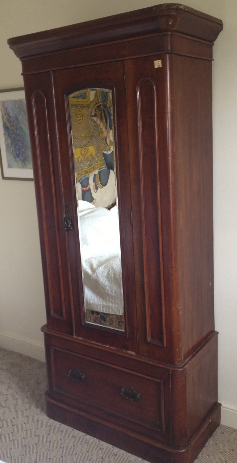 A Victorian mahogany mirror door Wardrobe, of unusually narrow proportions, with large base