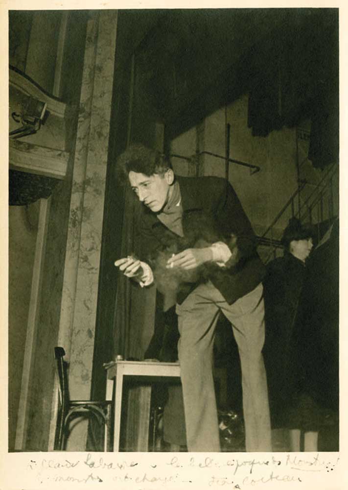 COCTEAU, JEAN Photograph Signed - (SP) A 10x7.5" photograph of Cocteau rehearsing on stage with a