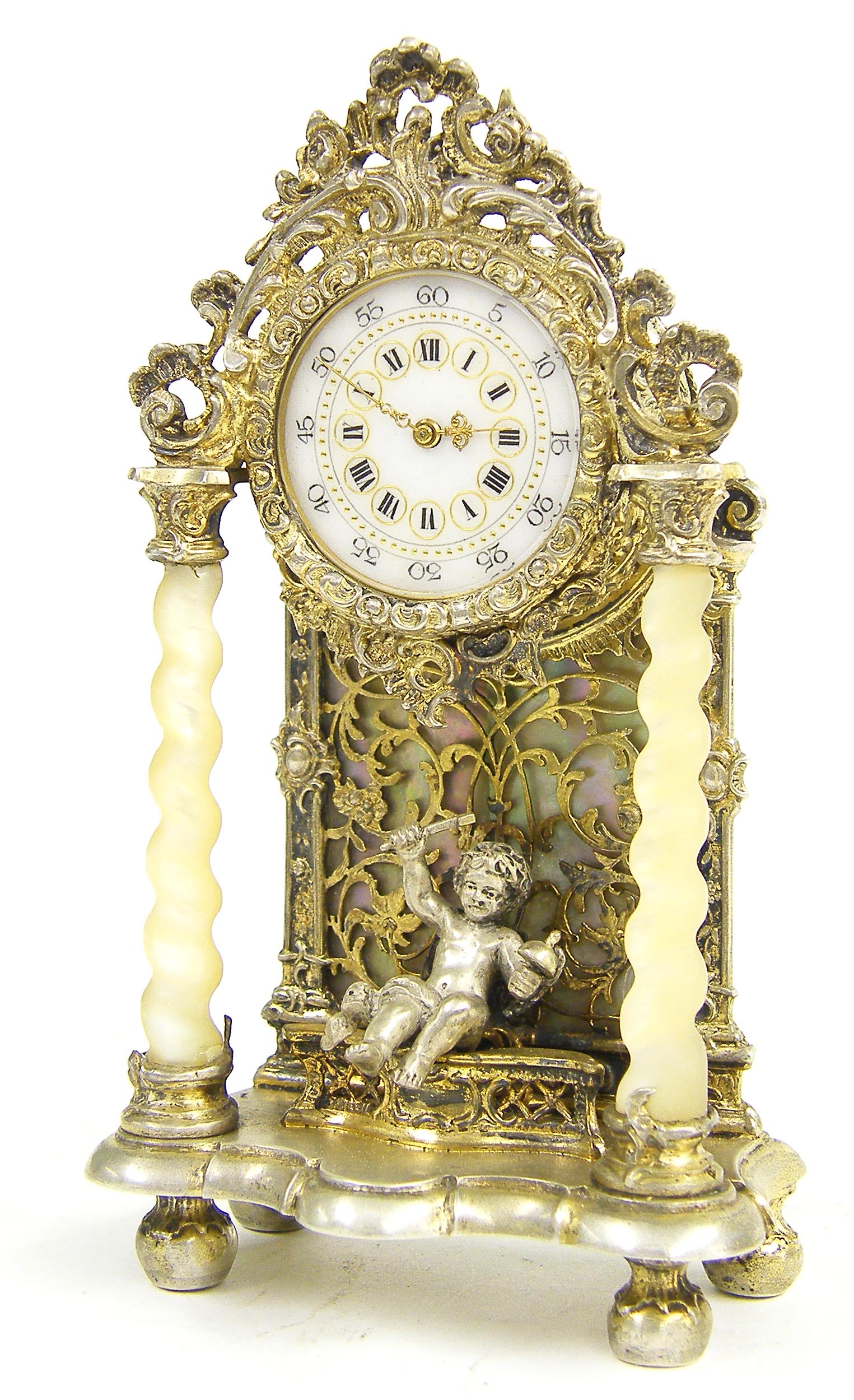 Gilded filigree miniature mantel clock, the dial in a drumhead casing over a seated musical