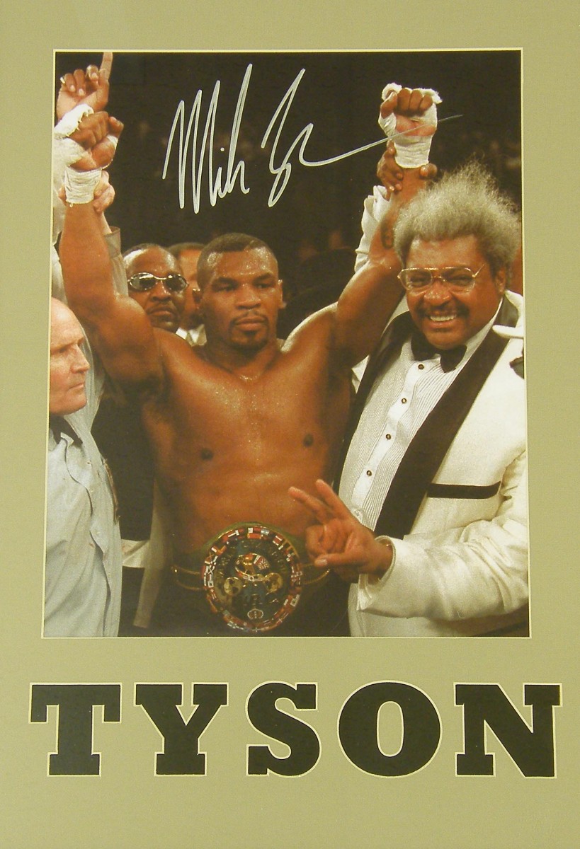 Mike Tyson - signed photograph with Tyson`s arms being raised by referee Mills Lane and Don King,