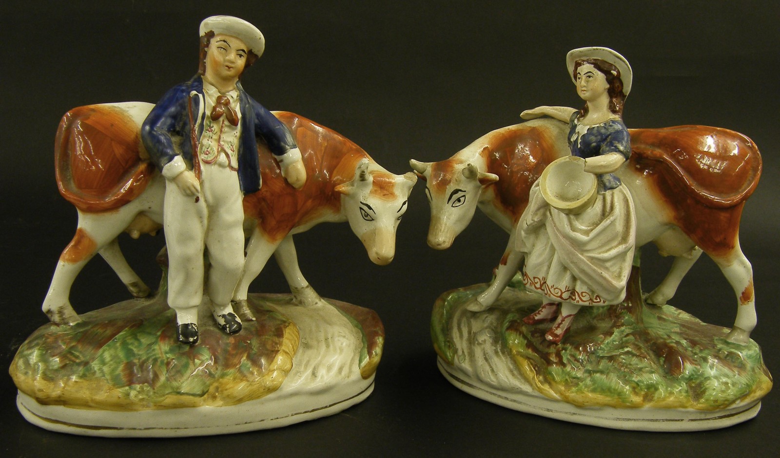 Pair of Victorian Staffordshire groups, modelled as a farmer and his partner with cattle, 9" high (