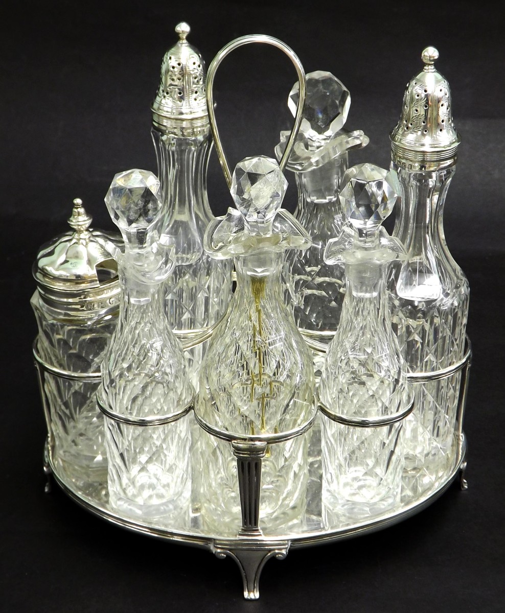 Georgian silver cruet set, fitted with seven associated bottles, the silver stand engraved with a
