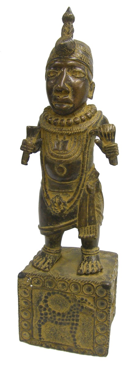 Tribal bronze figure of a man in traditional dress, on a base decorated with a big cat, 21" high