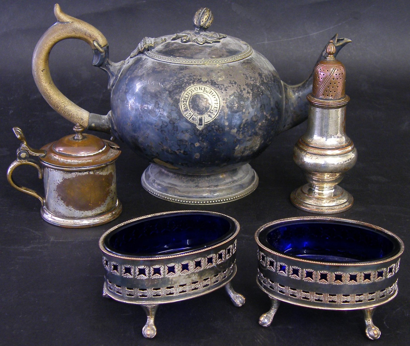 Pair of Sheffield plate table salts with blue glass liners and claw and ball feet, 3.5" wide;