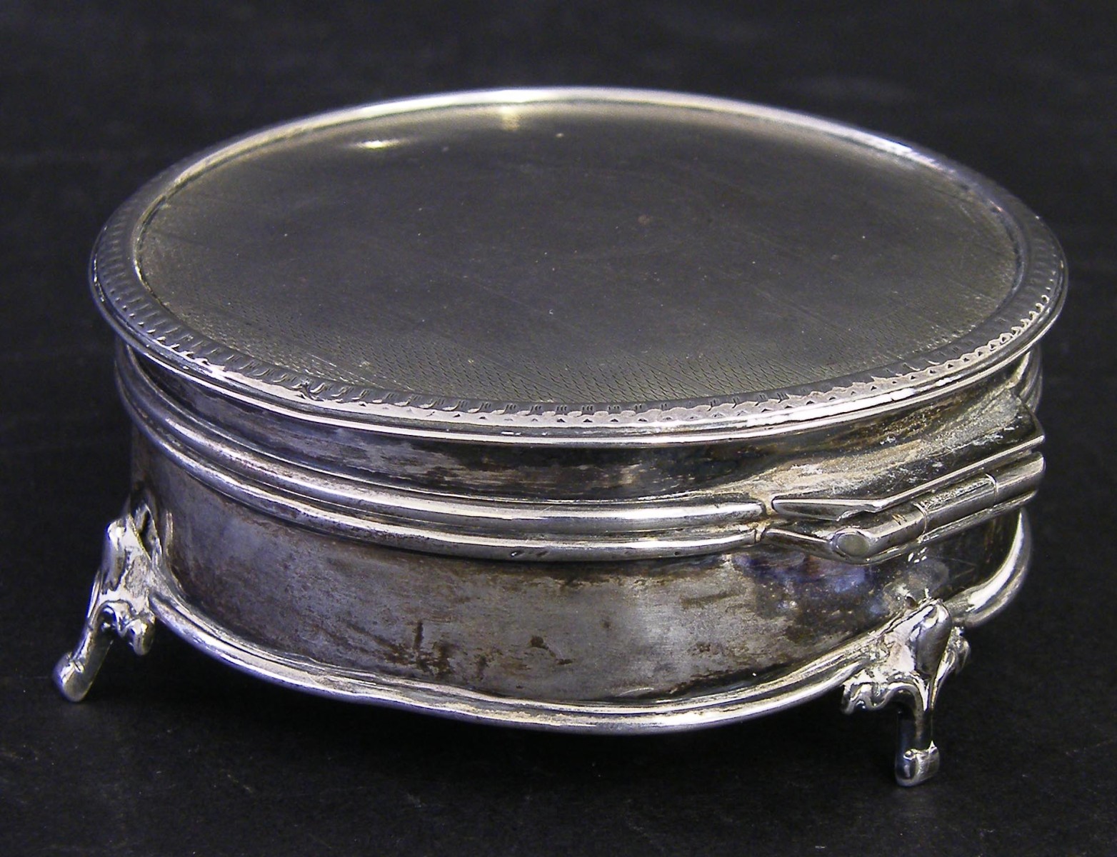 Mid 19th century silver lidded cylindrical box with engine turned lid and Fleur de Lys feet, maker`s