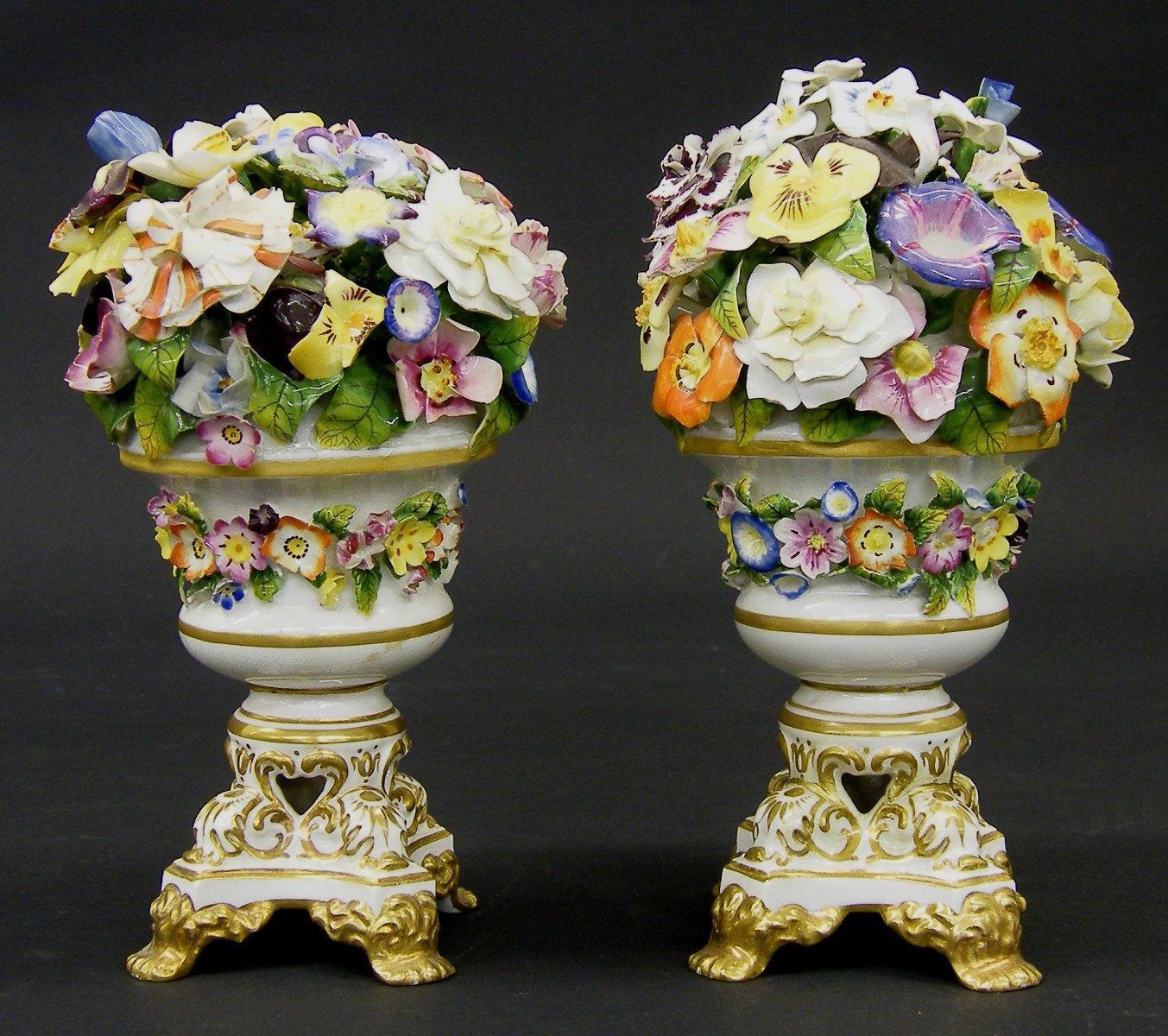 Pair of Derby porcelain floral bouquets, set within gilded quadrafoil urns, 7" high (2) (one