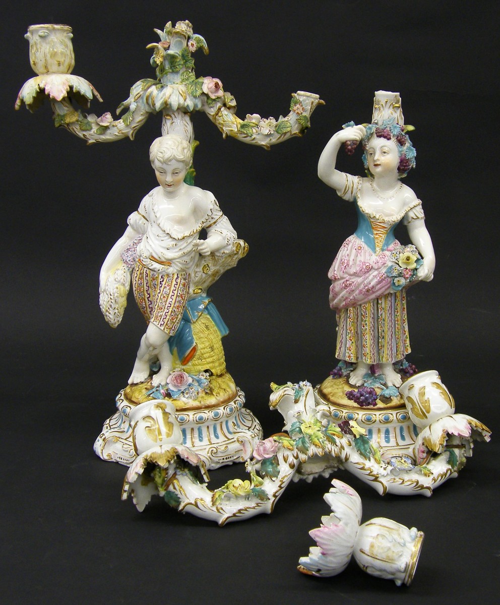 Pair of 19th century Continental porcelain candelabra, modelled as a harvester and flower picker,