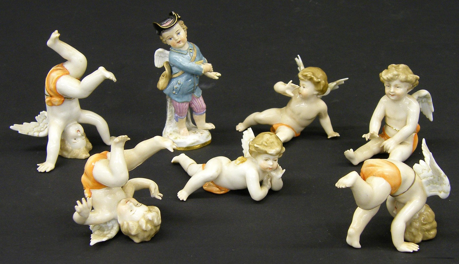 Set of six German porcelain figures modelled as playful cherubs; together with German porcelain