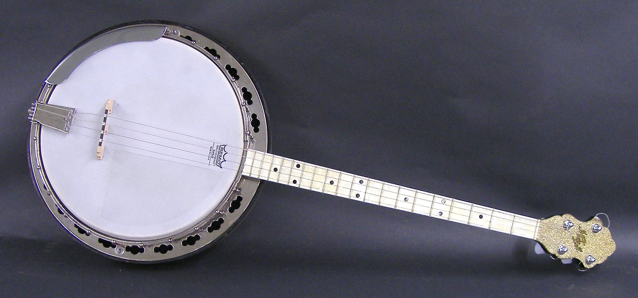 Slingerland May-Bell four string tenor resonator banjo, the shaped headstock signed May-Bell, gold