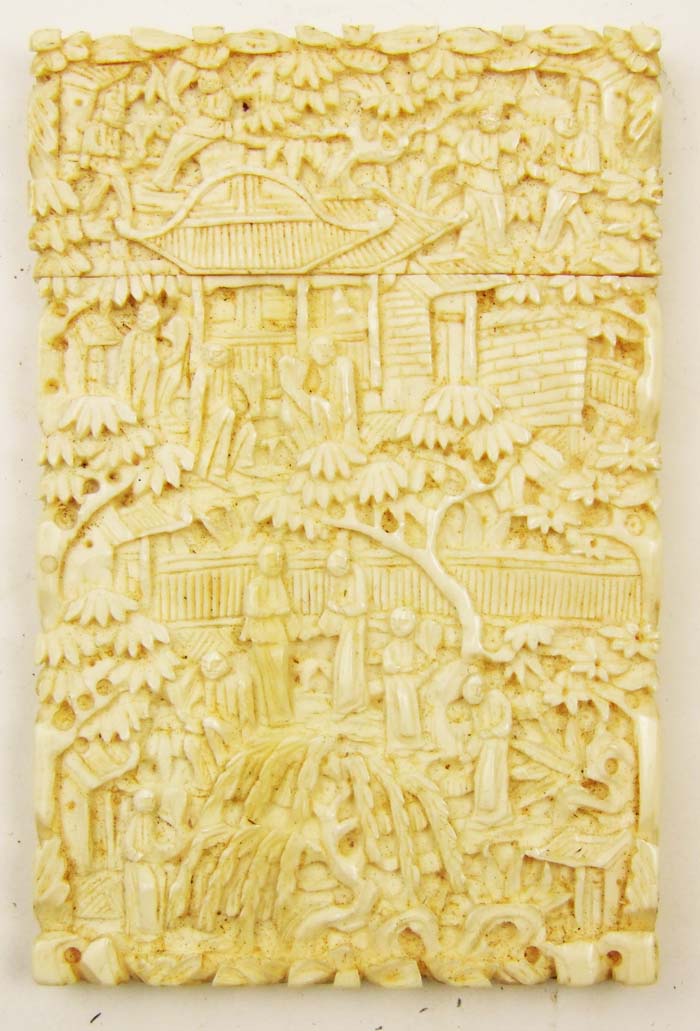 A Chinese Canton carved ivory card case, with allover figures and trees in relief, 10cm x 6.5cm (
