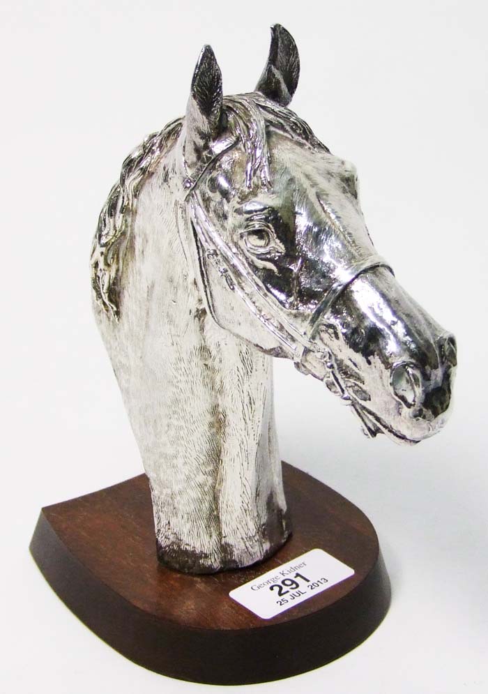 A silver horse’s head, signed D. Gerinty, on wooden plinth, maker’s mark of Camelot Silverware