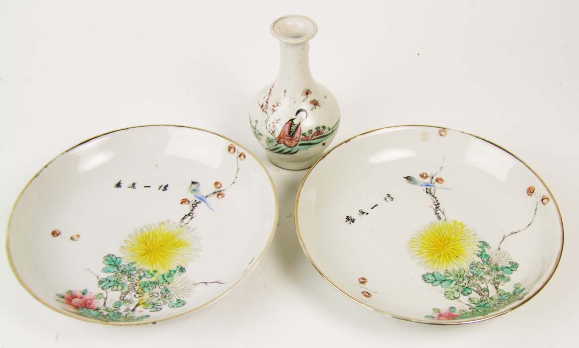 A pair of Chinese plates, the bowls with flowers and birds, and a signature, seal marks beneath,