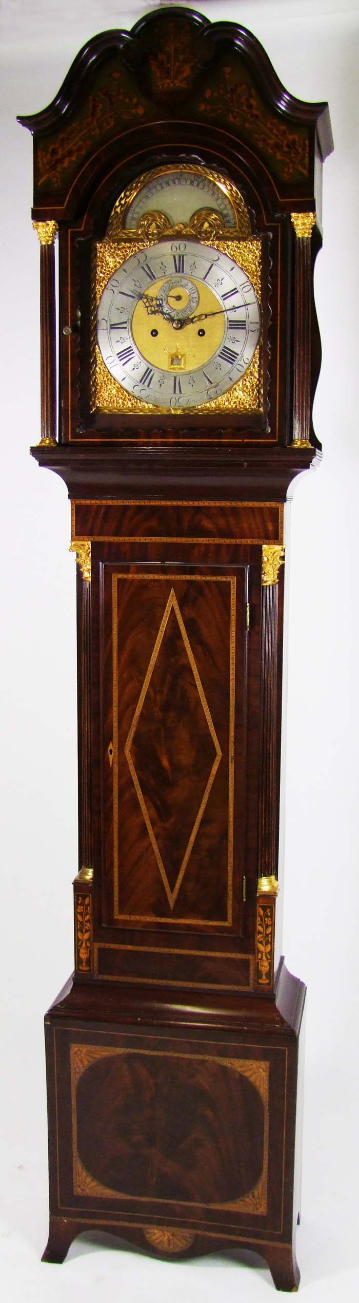 A mahogany and inlaid eight day longcase clock, the 31cm arched brass dial with silvered chapter