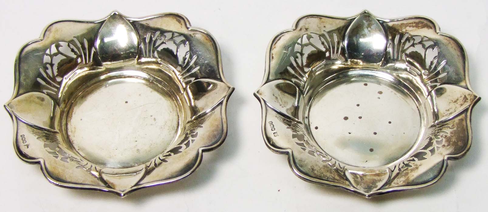 A pair of shaped square sweetmeat dishes, with petal moulding and pierced foliate decoration,