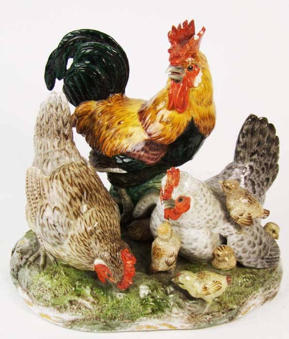 A Dresden group of a cockerel, two hens and six chicks, on naturalistic base, height 19cm (7 1/2in).