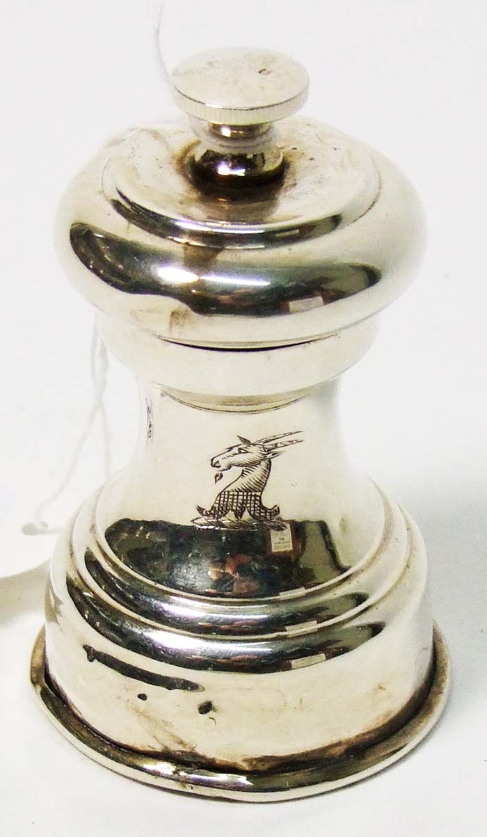 A capstan shaped pepper mill, chased with a crest, maker’s mark of William Hutton & Sons Ltd,