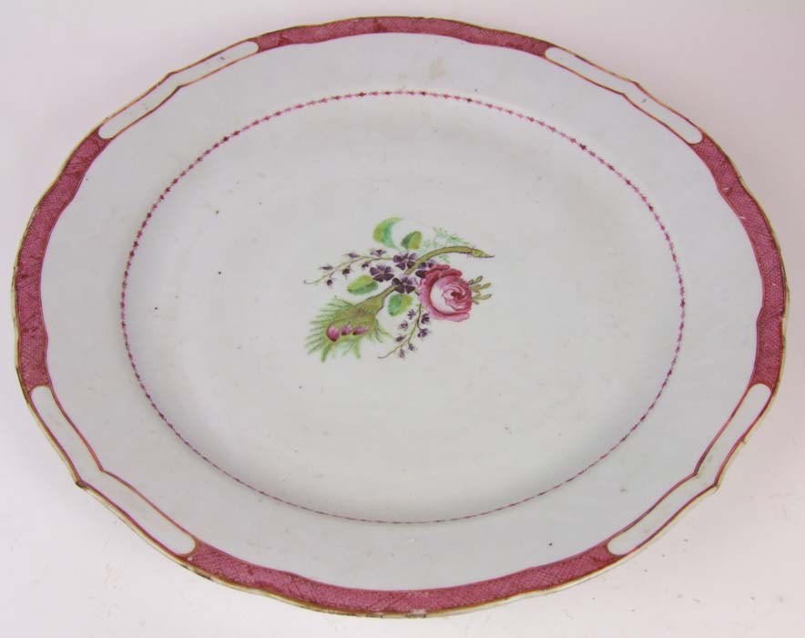 A 19th Century Chinese charger, the bowl with a central floral spray, and red lattice border,