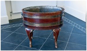 Fine Quality Mahogany Irish Type Wine Cooler Of Oval Form, with two board bands of brass collars