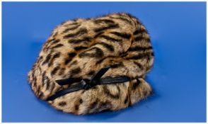 Ladies Young Leopard Fur Hat, cloche style with black leather trim forming a slight brim to the