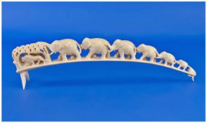 Carved Ivory Tusk, Showing A Herd Of Six Graduating Elephants And Two Lions, Length 16 Inches.