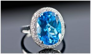 A 14k White Gold and Diamond Ring set with an oval cut blue topaz approx. 8ct. Diamond approx. 0.