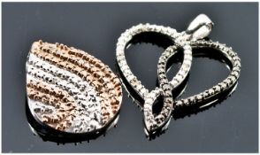 Two Diamond and Silver Pendants. 1) An entwined silver heart shaped pendant set with black and