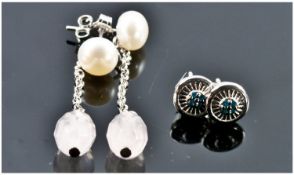 Two Pairs Of Earrings. 1) A pair of silver and blue diamond earrings. 2) A pair of silver and