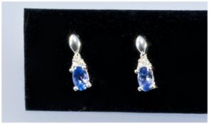 Pair of Tanzanite and Diamond Drop Earrings, each comprising a diamond in a triangular setting