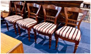 Set of Four Walnut Dining Chairs, with shaped waisted back rest with drop in seats. Raised  on