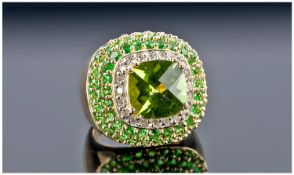 A 14k Yellow Gold and Diamond Ring Set with Tsavorite and Peridot. Round cut tsavorite approx. 5ct.