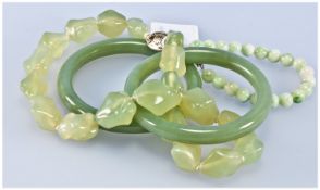 Collection Of Jadeite Stone Jewellery, Comprising Two Bangles, Round Bead Bracelet And A Freeform