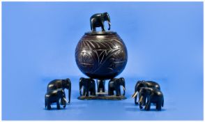 A 19th Century Ebony Carved Figural Lidded Bowl. To the bowl resting on 3 elephant figures, the lid