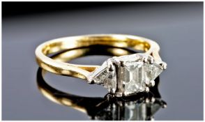 18ct Gold Set 3 Stone Diamond Ring. The central emerald cut diamond flanked by two triangle cut
