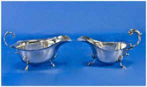 Silver Cream Jugs With Scroll Handles. Raised on hoofed feet and wavy edged borders. Hallmarks for