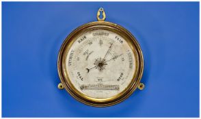 A Circular Maritime Brass Framed Barometer. Size 7 x 7 inches.