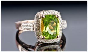 A 14k Rose Gold and Diamond Ring set with a cushion cut peridot approx. 3.20ct. Diamond approx. 0.