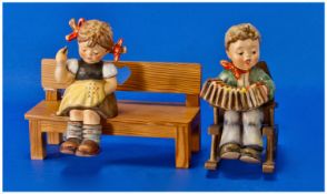 Goebel/Hummel First Issue Figures, 2 in total. 1). Nimble Fingers seated on bench HUM 758. 6.25