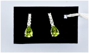 Peridot and White Topaz Drop Earrings, each with a pear cut, sparkling lime colour, Chinese