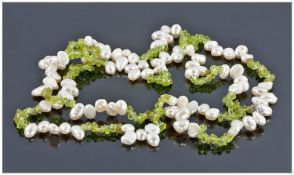 Chinese Peridot and Freshwater Baroque Pearl Necklace, comprising two strands of short rows of