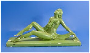 Art Deco Period Painted Chalk Figure in the form of a young semi glad woman in reclining position.